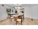 Well-lit dining room with a wooden table, modern chandelier, and beautiful decor with natural hardwood floors at 3798 S Wabash St, Denver, CO 80237