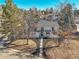 Charming two-story home featuring a gray roof, white paint and mature trees at 3798 S Wabash St, Denver, CO 80237