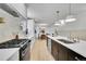 Bright kitchen features stainless steel appliances, white countertops and a view into the dining area at 3798 S Wabash St, Denver, CO 80237