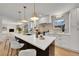 Spacious and modern kitchen with a large center island, pendant lights, and stainless steel appliances at 3798 S Wabash St, Denver, CO 80237