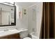 Bathroom featuring shower over tub, floral wall decor, vanity and mirror at 14444 E Colorado Dr # 204, Aurora, CO 80012
