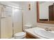 Cozy bathroom featuring a stand up shower, white tile, toilet, and sink vanity at 14444 E Colorado Dr # 204, Aurora, CO 80012