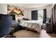 Bedroom with a calming ambiance featuring dark curtains for privacy and an art piece accentuating the space at 14444 E Colorado Dr # 204, Aurora, CO 80012