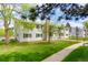 Two-story condo building with well maintained lawn and private patios at 14444 E Colorado Dr # 204, Aurora, CO 80012