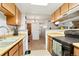 Functional kitchen featuring wooden cabinets, a gas range stove, and easy access to the dining area at 14444 E Colorado Dr # 204, Aurora, CO 80012