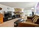 Inviting living room featuring a stone fireplace and a comfortable seating area with a cozy, brown sofa at 14444 E Colorado Dr # 204, Aurora, CO 80012