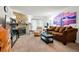 Cozy living room with stone fireplace, comfortable seating, and bright natural light streaming through the sliding doors at 14444 E Colorado Dr # 204, Aurora, CO 80012