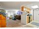 Open-concept living area with stone fireplace, comfortable seating, and a view into the adjacent kitchen at 14444 E Colorado Dr # 204, Aurora, CO 80012