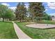 Community park with a walking path, mature trees and picnic tables at 14444 E Colorado Dr # 204, Aurora, CO 80012