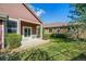 View of shady backyard with green lawn, mature trees, patio, and well-kept landscaping at 6475 Umber Cir, Arvada, CO 80007