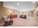 A comfortable basement area with plush seating, neutral walls, and recessed lighting at 6475 Umber Cir, Arvada, CO 80007