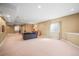 Large open basement with multiple seating areas, recessed lights, and beige carpet at 6475 Umber Cir, Arvada, CO 80007
