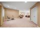 Spacious carpeted basement featuring an exercise bike, seating, and neutral walls at 6475 Umber Cir, Arvada, CO 80007