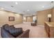 A finished basement area offering plush seating and a large space for entertaining at 6475 Umber Cir, Arvada, CO 80007