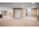 Expansive carpeted basement with storage and access to the upper floor at 6475 Umber Cir, Arvada, CO 80007