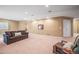A large basement featuring comfortable seating, neutral walls, and recessed lighting at 6475 Umber Cir, Arvada, CO 80007
