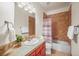 Bathroom showcasing tile flooring, a vanity, and a shower-tub combo at 6475 Umber Cir, Arvada, CO 80007