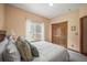 Bright bedroom featuring a large window, closet, and carpeted floor at 6475 Umber Cir, Arvada, CO 80007