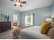 Comfortable bedroom featuring an ensuite bathroom and soft color palette at 6475 Umber Cir, Arvada, CO 80007