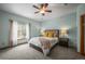 Inviting bedroom with light blue walls, soft carpet, and a ceiling fan at 6475 Umber Cir, Arvada, CO 80007