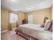 A cozy bedroom featuring a warm ambiance with an inviting queen-sized bed and ample natural light at 6475 Umber Cir, Arvada, CO 80007