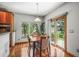 Cozy dining area featuring hardwood floors, a window view, and easy access to the outdoor space through sliding glass doors at 6475 Umber Cir, Arvada, CO 80007