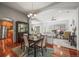 Elegant dining area with hardwood floors and open view of the kitchen and living room at 6475 Umber Cir, Arvada, CO 80007