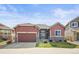 Charming single-Gathering home with a two-car garage and manicured lawn on a sunny day at 6475 Umber Cir, Arvada, CO 80007