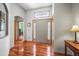 Elegant foyer with hardwood floors, stylish front door, and decorative window above at 6475 Umber Cir, Arvada, CO 80007