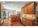 Well-equipped kitchen with stainless steel appliances, granite countertops, and hardwood floors, open to dining area at 6475 Umber Cir, Arvada, CO 80007