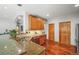 Kitchen with granite countertops, wood cabinets, and hardwood floors offers a seamless transition to adjacent rooms at 6475 Umber Cir, Arvada, CO 80007