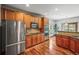 Updated kitchen with stainless steel appliances, granite countertops, and hardwood floors, offering a seamless flow to dining area at 6475 Umber Cir, Arvada, CO 80007