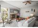 Cozy living room with a stone fireplace, comfortable seating, and a ceiling fan at 6475 Umber Cir, Arvada, CO 80007
