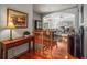 Open-concept living area with hardwood floors, staircase, and view into the living room and dining area at 6475 Umber Cir, Arvada, CO 80007