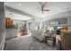Bright and open living room features cozy seating, a fireplace, and access to the dining area at 6475 Umber Cir, Arvada, CO 80007