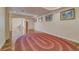 Finished basement area featuring hardwood floors and a large oval rug for added comfort at 2462 W Peakview Ct, Littleton, CO 80120