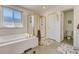 Bright bathroom features a soaking tub and a separate glass enclosed shower at 2462 W Peakview Ct, Littleton, CO 80120