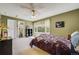 Comfortable bedroom features a ceiling fan, large window, and ensuite bathroom at 2462 W Peakview Ct, Littleton, CO 80120