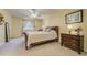 Bedroom featuring a ceiling fan, window with curtains and dresser with mirror at 2462 W Peakview Ct, Littleton, CO 80120