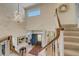 Bright entryway features a striking chandelier, staircase, and views into the living room at 2462 W Peakview Ct, Littleton, CO 80120