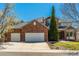 Charming two-story brick home with a three-car garage and well-maintained landscaping at 2462 W Peakview Ct, Littleton, CO 80120