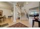 Bright foyer showcasing a grand staircase, hardwood floors, and elegant chandelier lighting at 2462 W Peakview Ct, Littleton, CO 80120