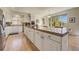 Spacious kitchen with white cabinetry, tile countertops, and ample natural light at 2462 W Peakview Ct, Littleton, CO 80120
