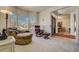 Cozy living room filled with natural light features comfortable seating, and opens to the foyer at 2462 W Peakview Ct, Littleton, CO 80120