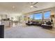 Open living space with hardwood floors, large windows, and a spacious sectional at 2462 W Peakview Ct, Littleton, CO 80120