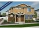 Charming new two-story home featuring a covered entryway and professionally landscaped front yard at 22152 E 38Th Pl, Aurora, CO 80019