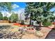 Inviting backyard featuring a fire pit with stump seating, perfect for outdoor gatherings and relaxation at 426 Jupiter Dr, Lone Tree, CO 80124