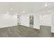 An open basement area with light gray floors and access to an updated bathroom at 426 Jupiter Dr, Lone Tree, CO 80124