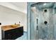 An updated bathroom with blue marble tile, modern vanity, and glass enclosed shower at 426 Jupiter Dr, Lone Tree, CO 80124