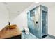 A modern bathroom with blue tile shower, luxury fixtures, and stone countertop at 426 Jupiter Dr, Lone Tree, CO 80124